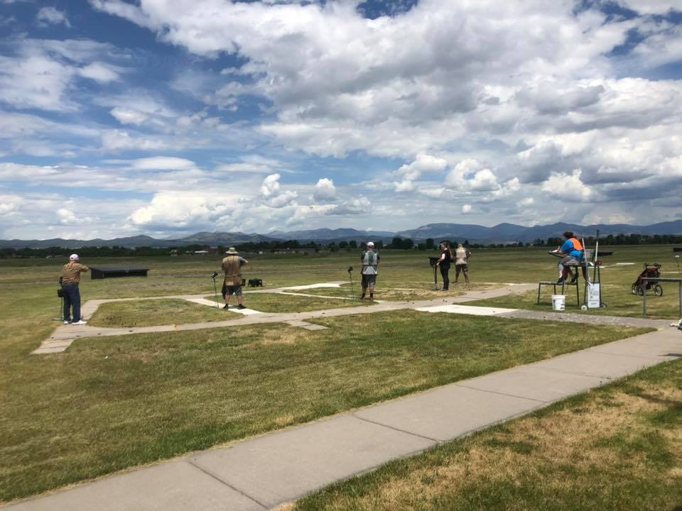 Trapshooters at Helena Trap Club beneath a wide Montana sky and mountain horizon